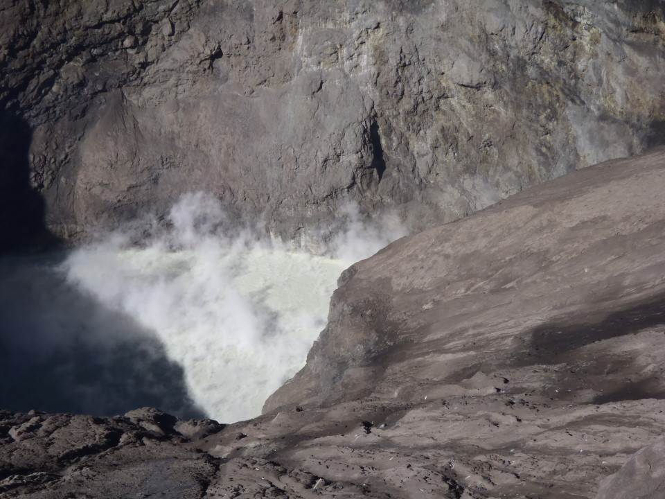 the crater inside constantly belches white sulphurous smoke